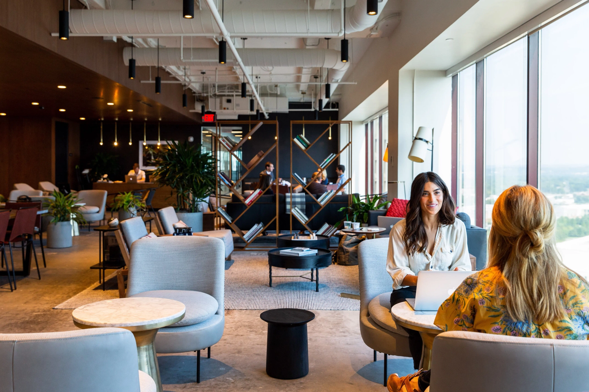 Two people sitting in a coworking space